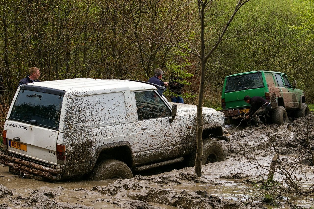 Mastering the First Impression: Your intriguing post title goes here Nissan vehicles engaged in challenging off-road mud adventure in Stadtoldendorf, Germany.